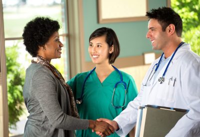 Health care team speaking with a patient.