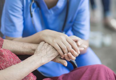 Asian eldery  woman with her caregiver at home. Home care or Elderly care concept.