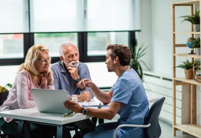 Happy senior couple having consultations with their doctor at his office.